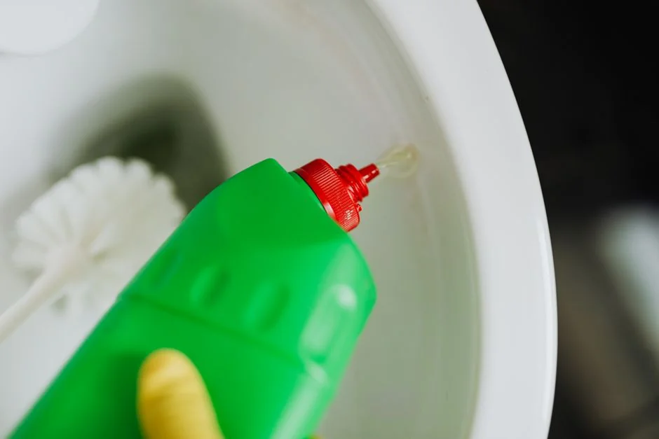 An adult male cleaning a glass window indoors, focusing on household chores and cleanliness.